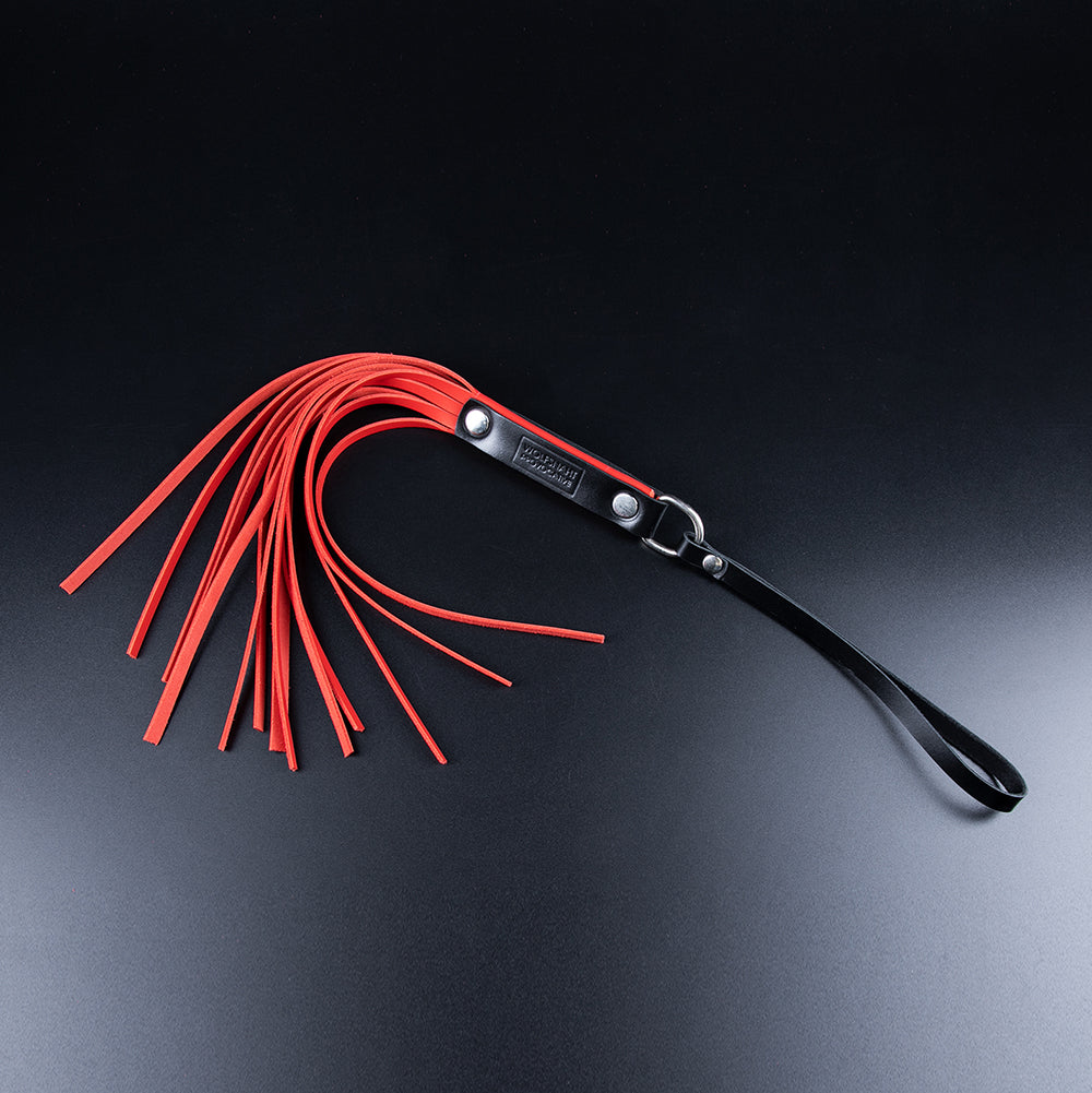 Red genital flogger