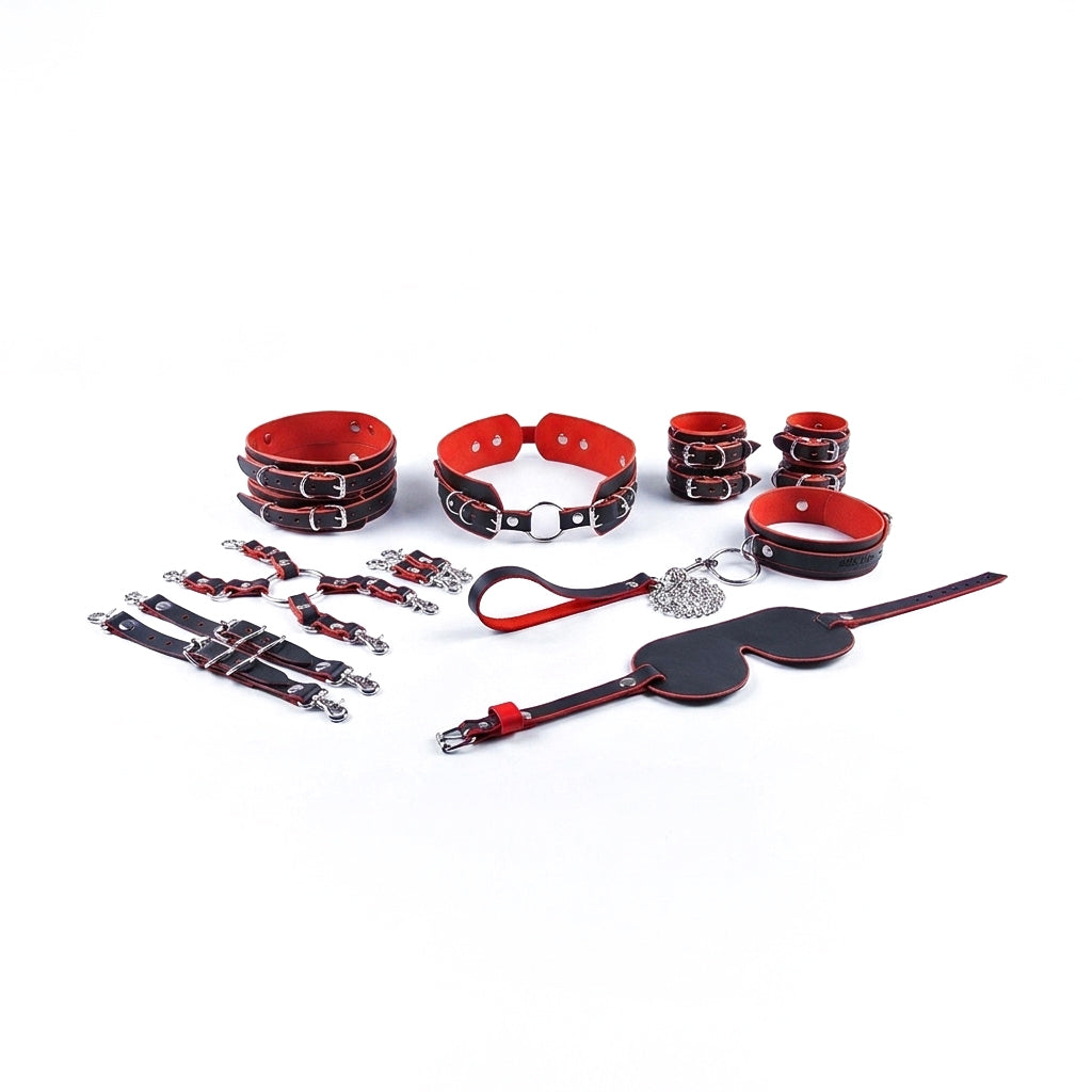 Collection of red and black leather bondage accessories on a white background